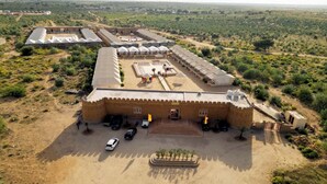 A large, fortified building with multiple tents and a central courtyard. - Experience the Best Jaisalmer Desert Safari & Luxury Camp Stay (Jaisalmer)