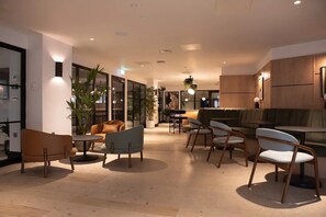 A modern interior with a seating area, a bar, and a dining space. - Student Only Centre Court (Nottingham)