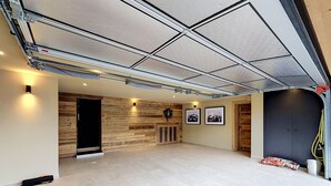 A spacious indoor area with a high ceiling, wooden wall paneling, and a tiled floor. - Stunning half-chalet in the village centre - 8 guests (Combloux)