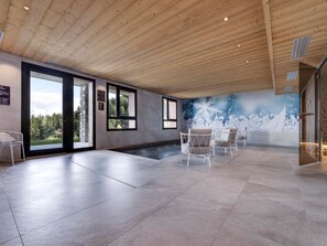 A spacious indoor area with a large window, a small pool, and a mural of a snowy landscape. - Modern apt with Spa and parking, Arc 1800 (Les Arcs 1800)