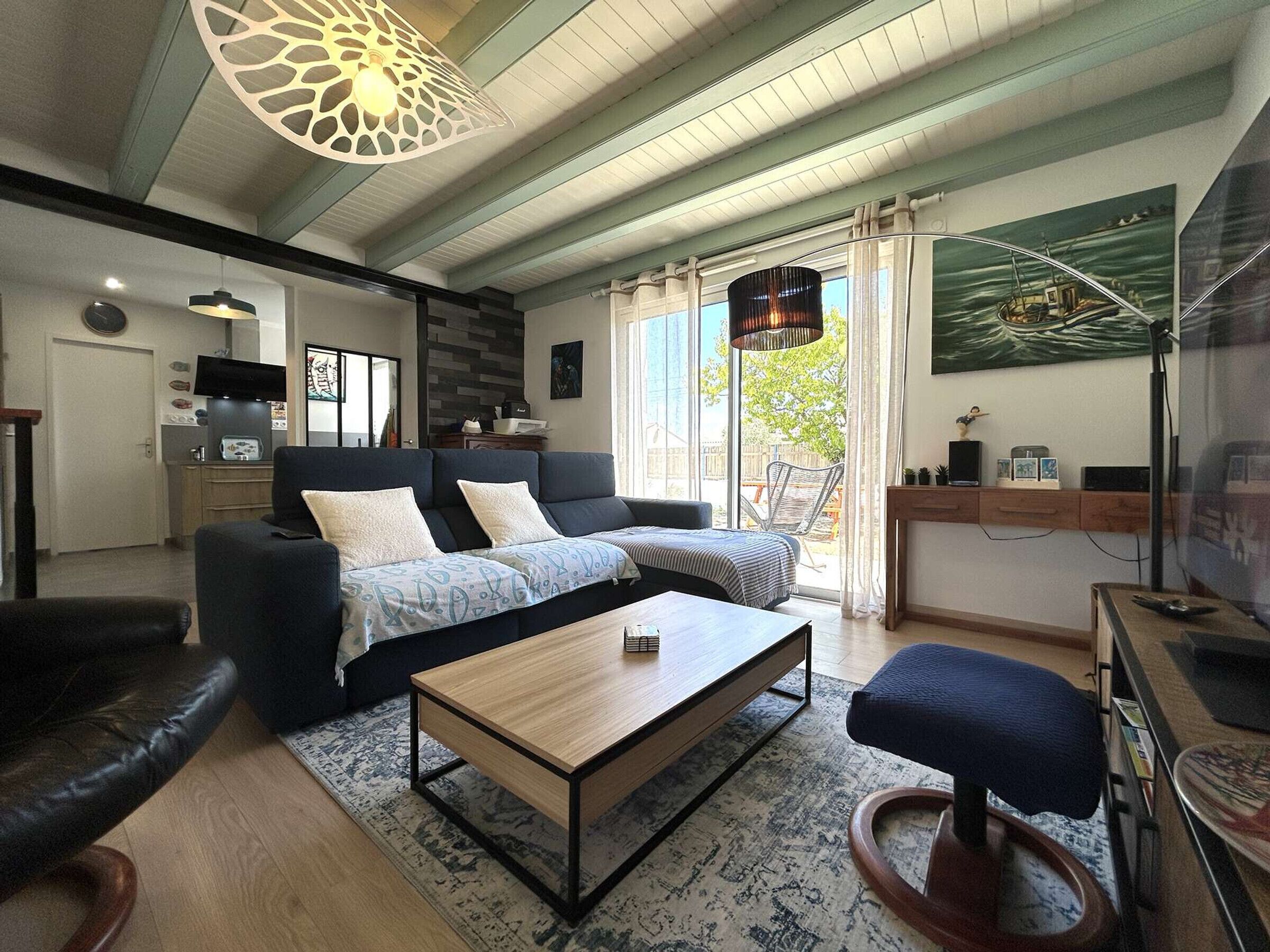 A modern living room with a sofa, coffee table, and a television.