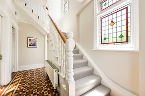 A staircase with a white balustrade and a patterned floor. - Birchwood House London (Greater London)