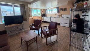 A compact living space with a television, seating area, kitchenette, and a view of the outdoors. - Sunset Studio, Best walkable location in Arcata & Bay View Studio (Arcata)