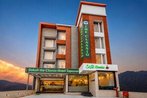 A hotel with a prominent sign for 'Daksh the Classio Hotel Tapovan' and a café named 'Café Classio' on the ground floor. - Daksh The Classio Hotel Tapovan (Rishikesh)