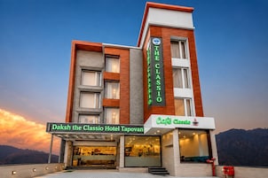 A hotel with a prominent sign for 'Daksh the Classio Hotel Tapovan' and a café named 'Café Classio' on the ground floor.