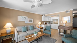 A living room with a sofa, armchairs, a coffee table, and a ceiling fan. - Sunswept 304 by Liquid Life (Orange Beach)