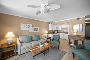 A living room with a sofa, armchairs, a coffee table, and a ceiling fan. - Sunswept 304 by Liquid Life (Orange Beach)