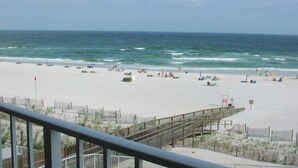 A beach with a wooden pier, sandy beach, and ocean view. - Sunswept 402 by Liquid Life (Orange Beach)