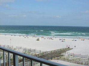 A beach with a wooden pier, sandy beach, and ocean view. - Sunswept 402 by Liquid Life (Orange Beach)