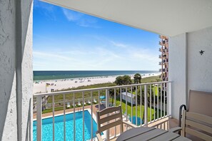 A balcony with a view of a beach and a swimming pool. - Sunswept 406 by Liquid Life (Orange Beach)