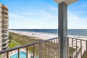 A beachfront hotel with a pool, beach view, and a balcony. - Sunswept 601 by Liquid Life (Orange Beach)