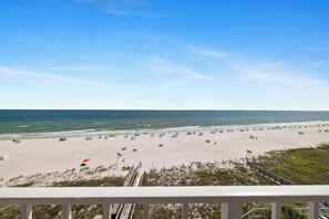 A beach with a wooden boardwalk leading to the shore, a clear sky, and the ocean. - Sunswept 701 by Liquid Life (Orange Beach)