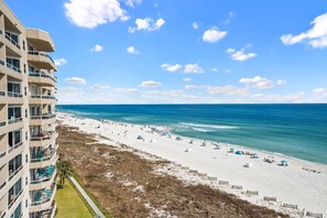 A beachfront hotel with multiple balconies overlooking the beach and ocean. - Sunswept 801A by Liquid Life (Orange Beach)
