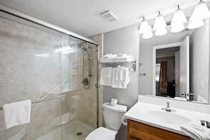 A modern bathroom with a glass-enclosed shower, a white sink, and a mirror above the vanity. - Seaside Beach & Racquet 5414 by Liquid Life (Orange Beach)