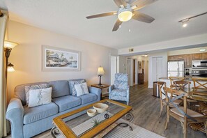 A living room with a sofa, coffee table, and a ceiling fan. - Seaside Beach & Racquet 5915 by Liquid Life (Orange Beach)