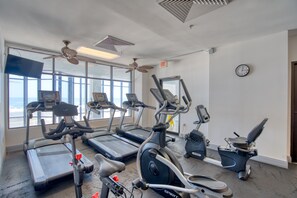 A gym with treadmills, stationary bikes, and an elliptical machine. - Summerchase 803 by Liquid Life (Orange Beach)