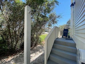 A wooden staircase leading to a house with a mailbox on the landing. - Kingfisher Cottage at Tannin by Liquid Life (Orange Beach)