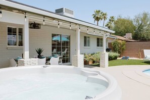 A backyard with a hot tub, outdoor seating, and a pool. - Muse: Scottsdale Home, Pool & Spa (Scottsdale)
