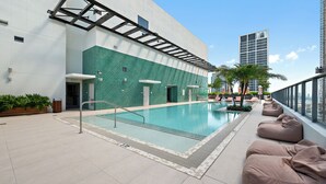 A rooftop pool area with a clear view of the city skyline, including a tall building. - The Crosby Balcony Studio Palermo Home (Miami)