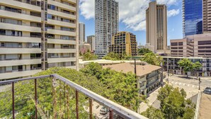 A multi-story building with balconies and a clear sky. - Waikiki Penthouse, 1 Free Parking, 3bdrm, Sleeps 6 (Honolulu)