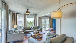 A spacious living area with a ceiling fan, large windows, and a view of the cityscape. - Waikiki Penthouse, 1 Free Parking, 3bdrm, Sleeps 6 (Honolulu)