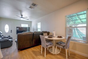 A dining area with a round table, chairs, and a ceiling fan. - Near San Antonio River Walk w/ Fenced Yard (San Antonio)