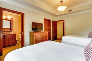 A hotel room with a large bed, a dresser, a mirror, and a television. - Ski-in/ski-out! Mtn-view Montage Deer Valley Condo (Park City)