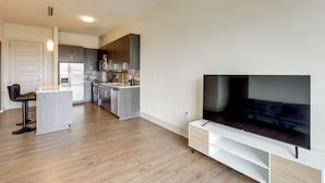 A modern kitchen with dark cabinets, a built-in oven, and a microwave. - Explore Dtwn Austin! Luxe High-rise Escape w/ Pool (Austin)