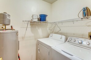 A laundry room with a washing machine, dryer, and a water heater. - Near Golf! Waterfront Unit w/ Pool in Sunset Beach (Sunset Beach)