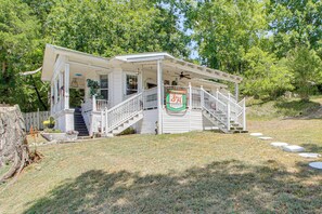 A two-story house with a porch, a staircase, and a sign for Green Stamps. - Walk to Bathhouse Row! Historic Gem w/ Yard (Hot Springs)