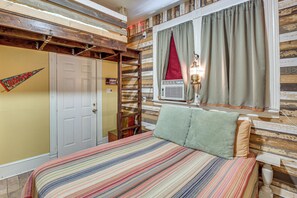 A room with a bed, a window with curtains, a radiator, and a wall with a wooden panel design. - Walk to Bathhouse Row! Historic Gem w/ Yard (Hot Springs)