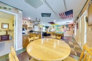 A room with a pool table, wooden chairs, a bar area, and a clock on the wall. - Shared BBQ Area & Pool! Cozy Home in Lake Charles (Lake Charles)