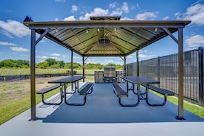 A covered picnic area with metal tables and benches, a grill, and a fenced outdoor space. - 2 Mi to Dtwn Crowley! 3-unit Rental (Crowley)