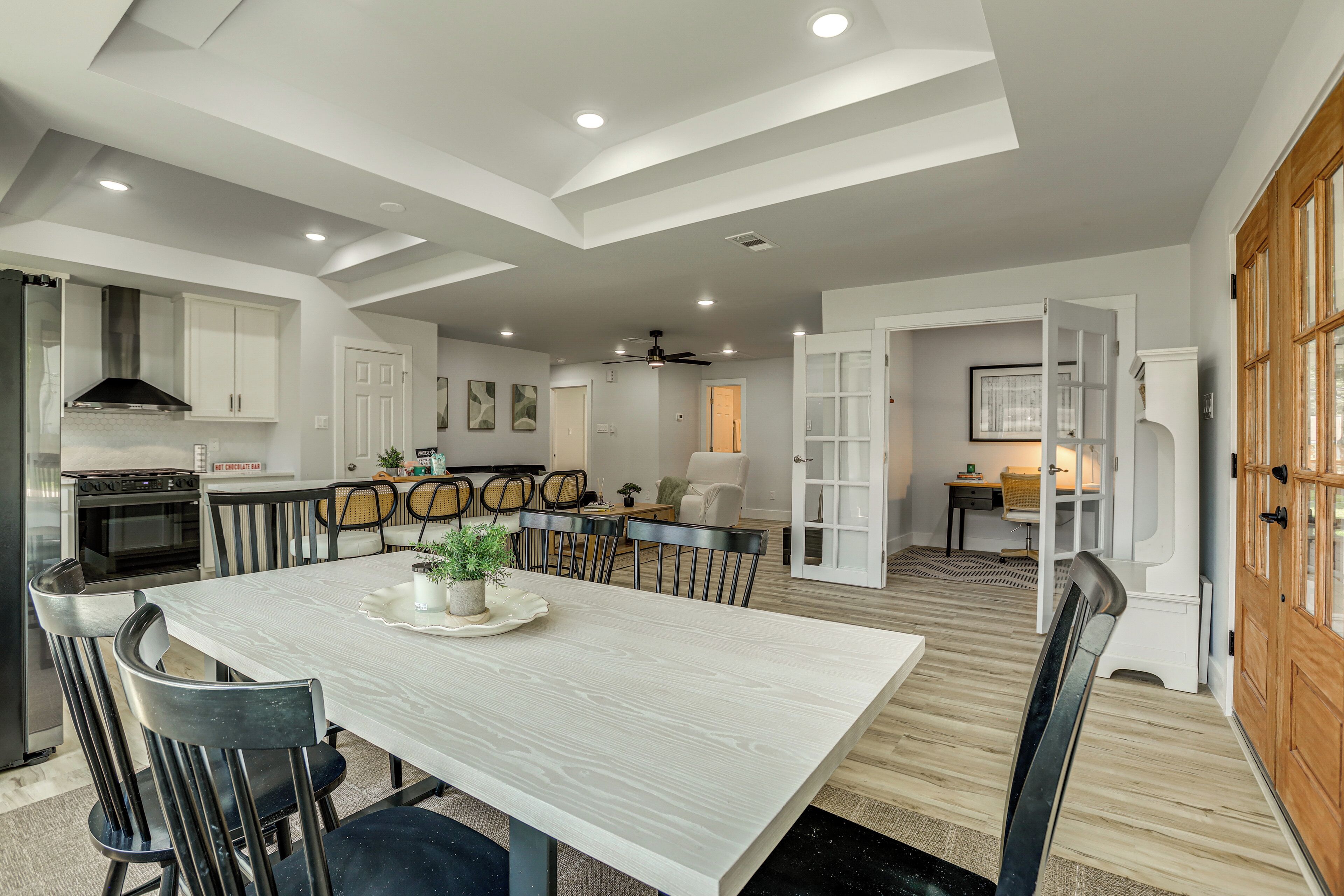 A spacious kitchen with modern appliances, a dining area with a large table, and a cozy living space with a fireplace.