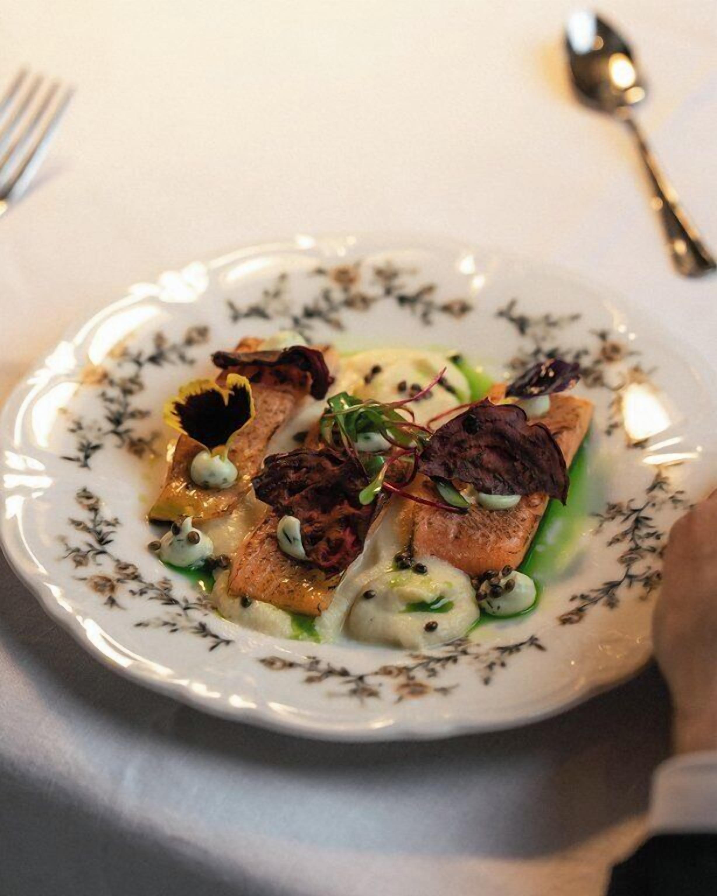 A plate of food with a floral pattern on the rim.