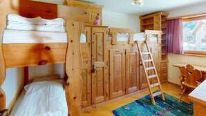 A wooden bunk bed room with a desk and a window. - Apartment Ambretta OG by Interhome (St. Moritz)
