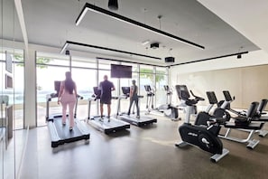 A modern gym with treadmills, elliptical machines, and weight equipment. - FIRST CLASS |1BR| Beachfront with Ain Dubai Views (Dubai Harbour)