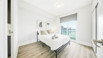 Premium bedding, desk, laptop workspace, blackout drapes