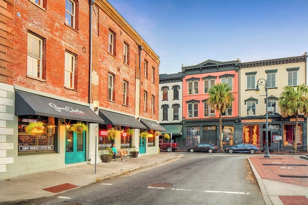 A street with buildings, a restaurant named 'Sorry Charlie's Oyster Bar,' and a theater.