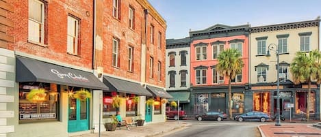 A street with buildings, a restaurant named 'Sorry Charlie's Oyster Bar,' and a theater.