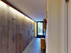 Ein Flur mit Holzvertäfelung und einem großen Fenster am Ende.
