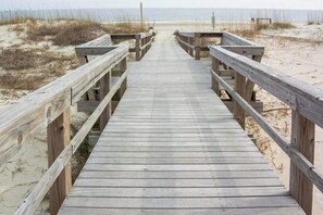 A wooden boardwalk leading to a beach. - Seaside serenity home with beach access, washer/dryer, & dog-friendly (Tybee Island)