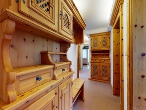 A hallway with wooden furniture, including a bench and cabinets. - Apartment Ova Cotschna 301 by Interhome (St. Moritz)