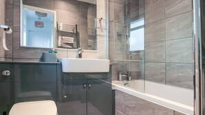A modern bathroom with a glass shower enclosure, a white sink, and a toilet. - Modern 2BR Apartment, S1 City Centre, WIFI, Sleeps 6 (Greater Manchester)