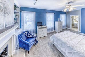 A bedroom with a bed, a desk, a chair, a dresser, and a bookshelf. - Modern Historic District duplex spacious and short walk to parks and restaurants (Savannah)