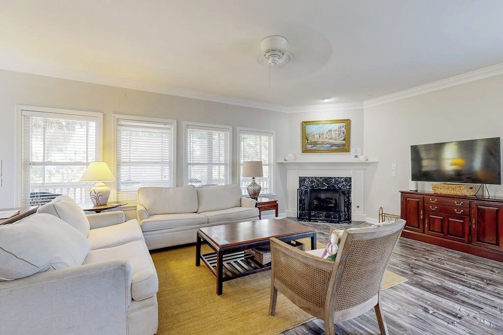 A living room with a sofa, coffee table, and a fireplace.