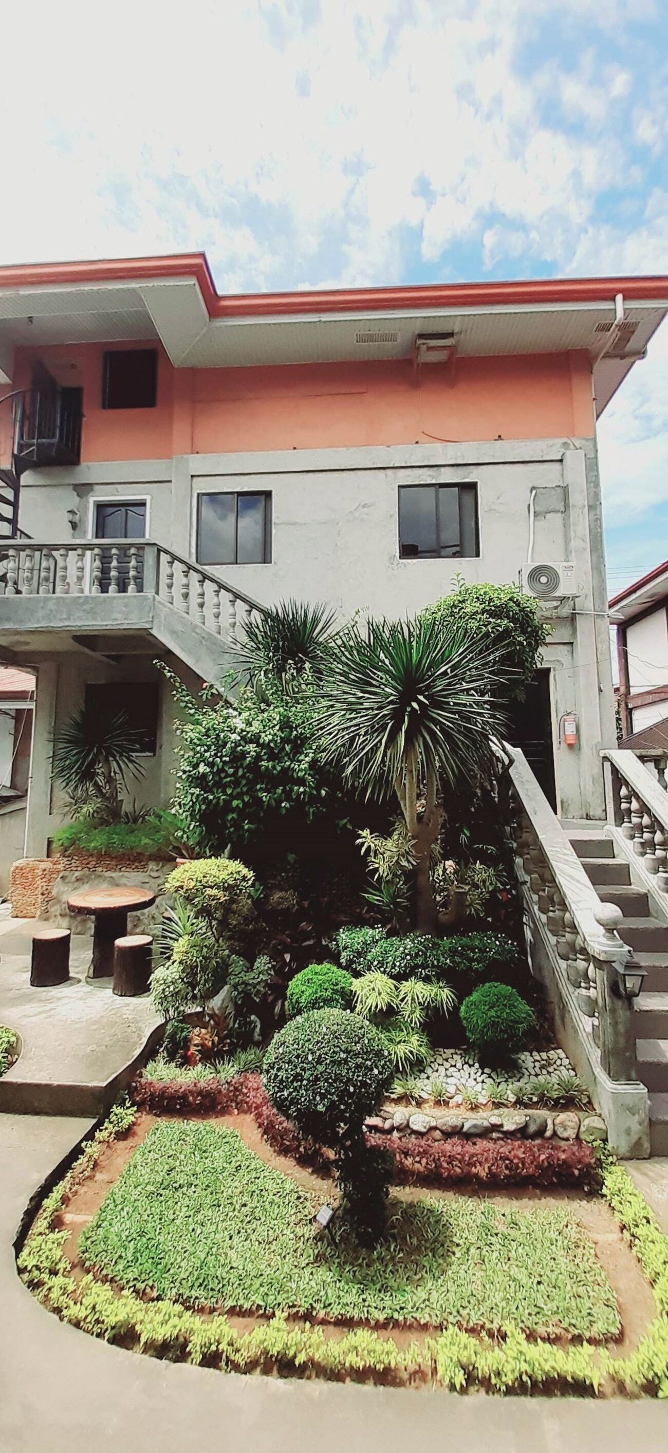 A two-story building with a balcony and a staircase.