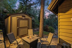 A wooden shed with a door, a fire pit, and two chairs outside. - Disney Imagineer-Built Chalet Near the slopes | Fire Pit, Trails | Hot Tub (Big Bear Lake)