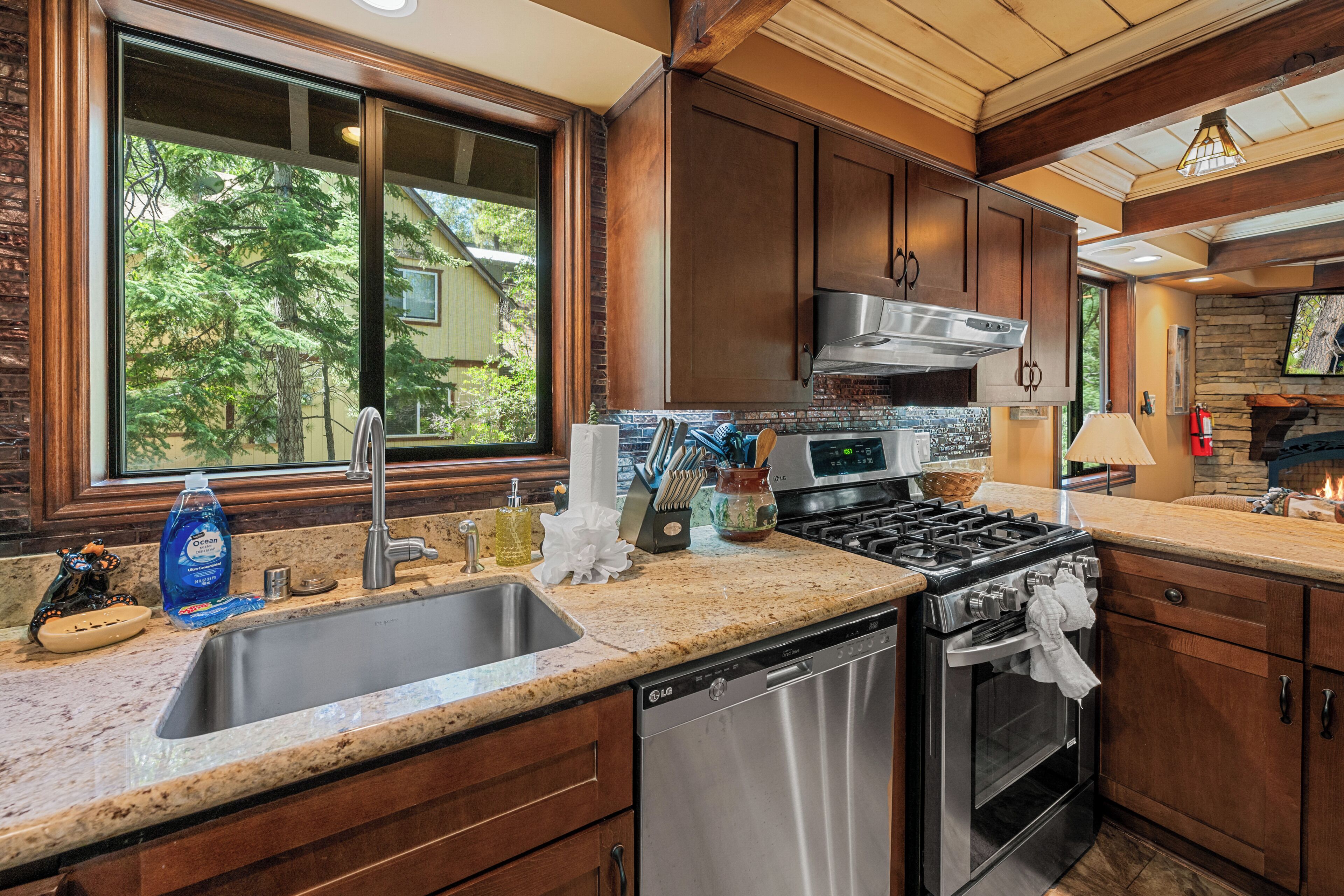A kitchen with a stainless steel dishwasher, a stove, and a microwave.