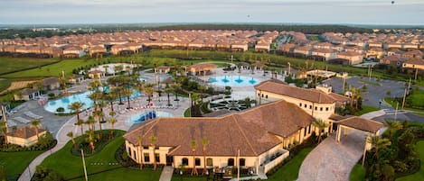 A residential area with a central swimming pool, multiple buildings, and a parking lot with handicapped accessibility.